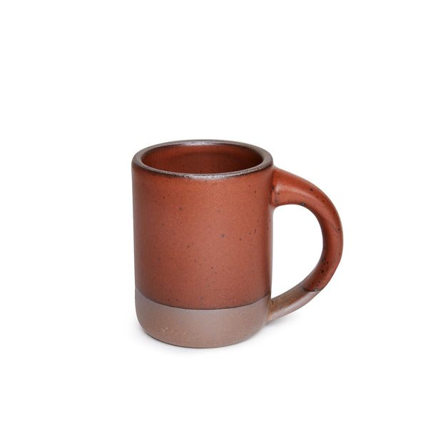 Handmade stoneware mug in a warm rust glaze with a bare clay base